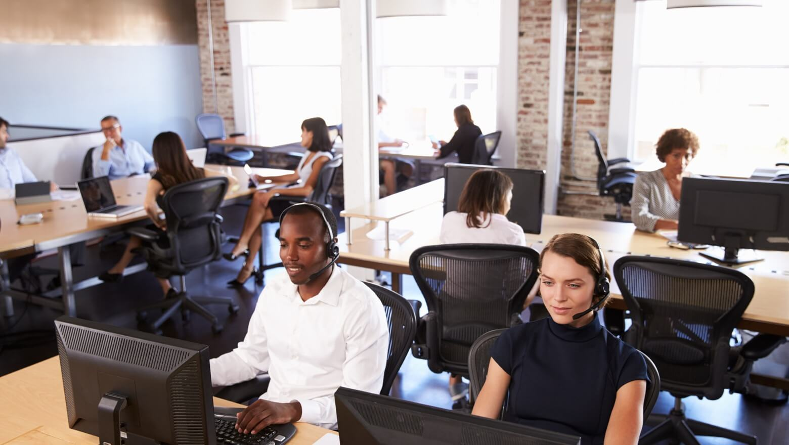 Professional attendants handling high-volume calls with headsets